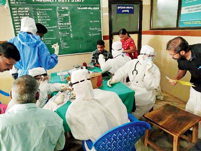 Medical personnel wearing protective suits check patients at the Medical College Hospital in Kozhikode. Pic/AFP