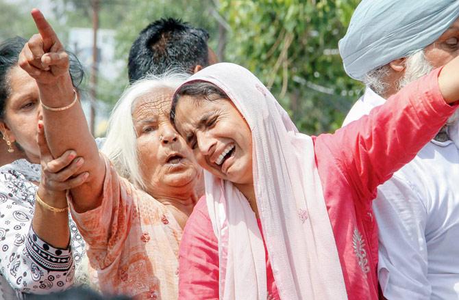 Women mourn during the funeral of the villagers killed in the shelling, on Friday. Pic/PTI