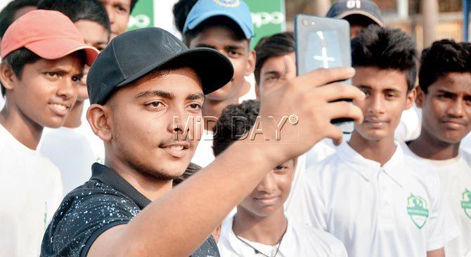 Mumbai batsman Prithvi Shaw takes a selfie with budding cricketers during an event in the city yesterday. Pic/Sayyed Sameer Abedi