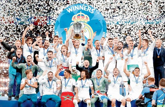 Real Madrid players take centrestage with the Champions League trophy after beating Liverpool 3-1 in Kiev, Ukraine on Saturday. Pics/AFP