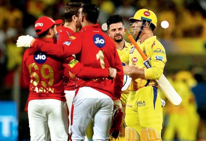 Mahendra Singh Dhoni (right) is congratulated by Punjab players after Chennai