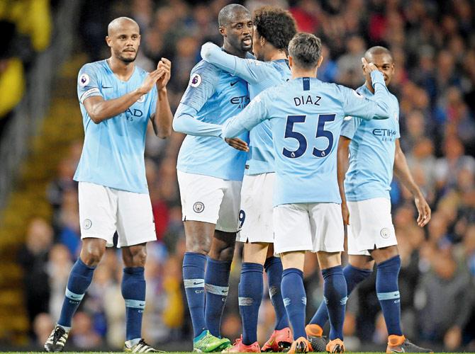 Yaya Toure (second from left) embraces teammate Leroy Sane after he is subbed in his final home appearance as a Man City player during an EPL match against Brighton on Wednesday. Pic/Getty Images