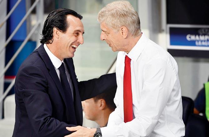 Unai Emery (left) greets Arsene Wenger before a Champions League match between PSG and Arsenal in 2016. Pic/Getty Images