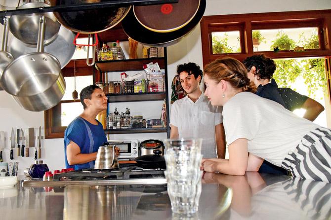 Artists gather by the open kitchen