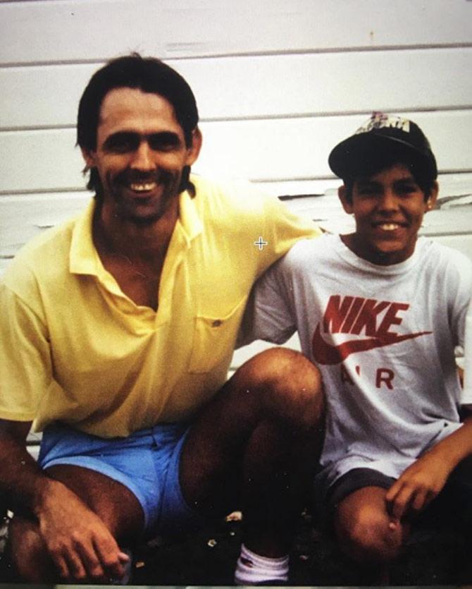 Mitchell Johnson posted this picture of his younger days with his father. Doesn't Mitchell Johnson's father look like an exact carbon copy of the fast bowler? Mitchell captioned this picture as, 'With my dad in my tennis playing days! #teeth #dad #smile #flatbrim #styling #middlefinger #twins'