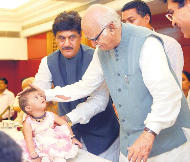In picture: Former Deputy Prime Minister of India Lal Krishna Advani blesses ten-month-old Prachiti Sawant, daughter of Parag Sawant who was injured in the 7/11 bomb blast attacks and went into a coma. The senior BJP leader is seen consoling the victims of the 7/11 bomb blast attacks at Ganshyamdas Saraf Vidyalaya in Malad (West) as party colleague, late Gopinath Munde looks on.