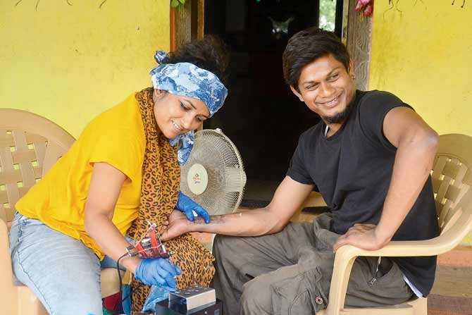 Mumbai-based tattoo artist Heerkani Sangram Bhosle tattooing Warli artist Ankush Tukaram Telawade. Bhosle has held similar demo sessions, using Warlis as subjects, to popularise Warli tattoos