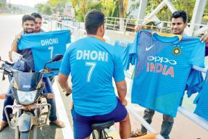 Hockey fans buy MS Dhoni jerseys from vendor outside Kalinga stadium