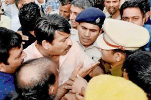 BJP leaders seek AAP MLA's arrest, wave black flags at CM