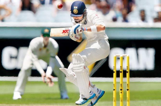Virat Kohli evades a bouncer from Australia Mitchell Johnson during the third Test at Melbourne in Dec 2014. Pic/Getty Images
