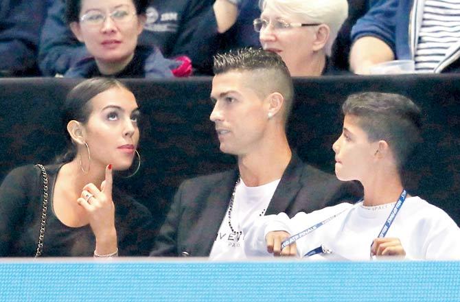 Juventus ace Cristiano Ronaldo (centre) with his girlfriend Georgina Rodriguez (left) and son Cristiano Junior during the ATP Finals match between Novak Djokovic and John Isner on Tuesday. Pic/AP,PTI