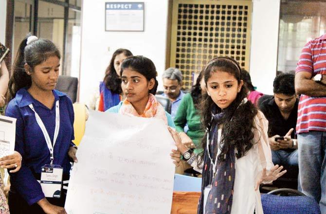 Child champion Saleha (right) interacts with other adolescents at a workshop