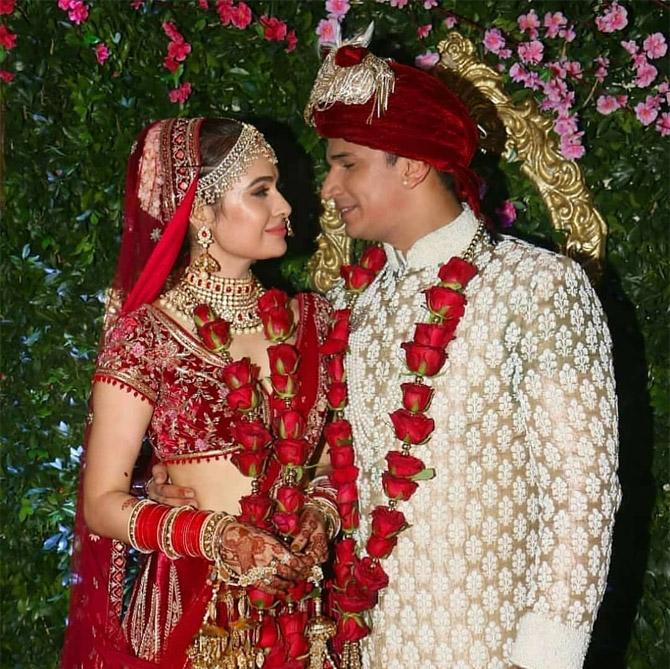 Yuvika Chaudhary opted for a traditional velvet maroon and golden wedding lehenga for the special occasion. Accentuating the look with 'chooda' and 'kaleerein' in hands and heavy jewellery, Yuvika looked ethereal. Prince Narula complemented his bride in a maroon turban, golden sherwani and mojris, which had white embroidery over it. The red rose garlands prove that the couple loves each other to the moon and back.