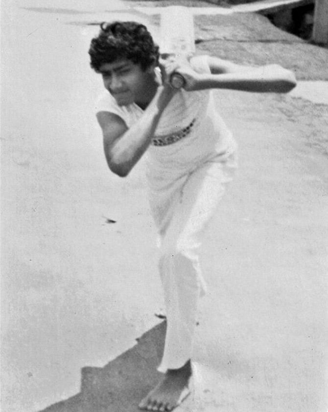A teenage Anil Kumble seen in this black and white photograph. Anil Kumble captioned, '#GoingBackInTime!! Most of the practice used to be on the streets! We grew up playing street cricket a lot! Good old memories! #Throwback'