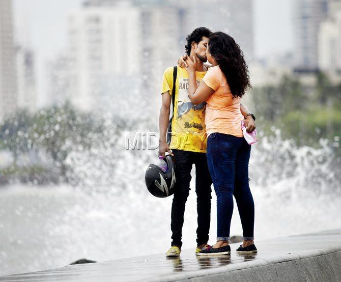 A couple in the city of Mumbai locks lips during a rainy evening at Marine Drive on June 10, 2017. Pic/ Pradeep Dhivar   