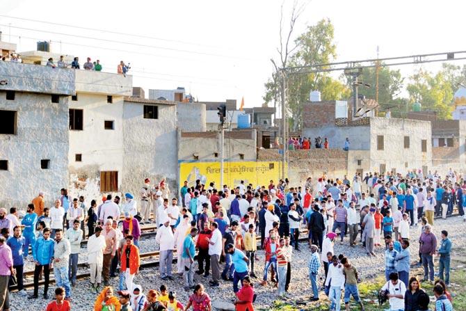 Locals gather at the scene of the accident on Saturday morning. Pics/PTI