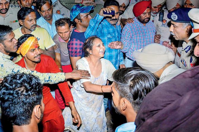 Relatives mourn at the site of the train accident on Friday