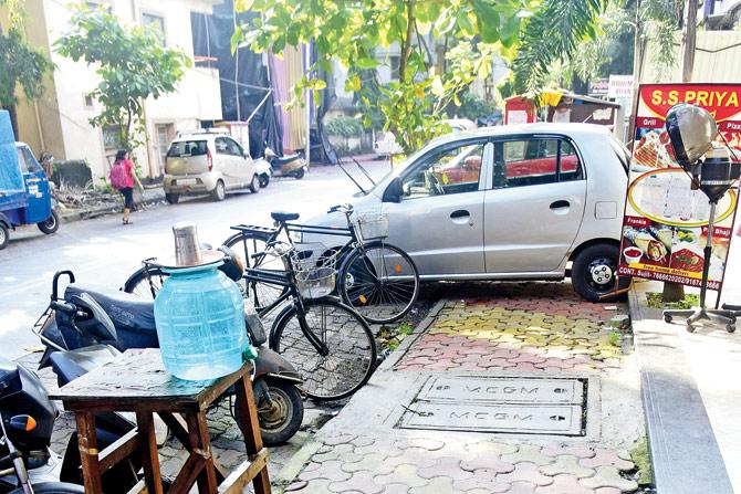 Haphazardly parked cars block footpaths in Mulund East. Bikes on a footpath on LBS Marg in Mulund West; haphazardly parked cars block footpaths in Mulund East. Pics/Sameer Markande