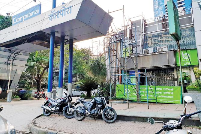 Bikes parked on the footpath outside Corporate Park on LBS Marg, Bhandup