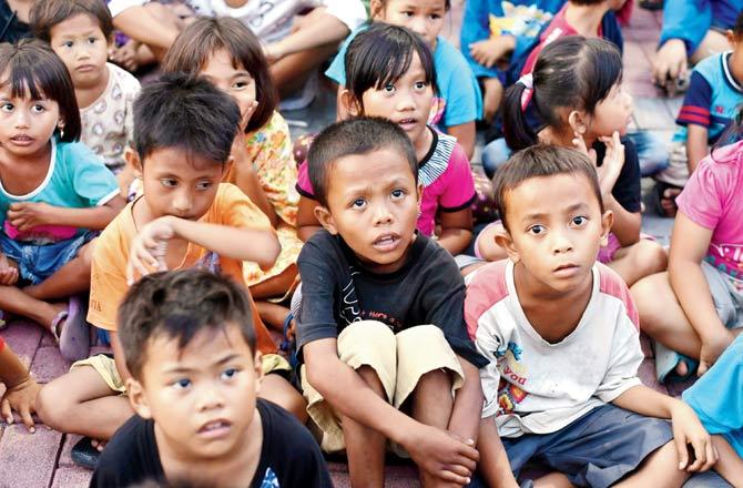 While children attend a trauma healing programme at a shelter, in Palu on Monday. Pics/AFP