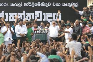 Sri Lankas sacked prime minister Ranil Wickremesinghe, center right in white shirt and black trousers, waves to his supporters along with law makers supporting him during a protest rally outside the prime ministers official residence in Colombo, Sri Lanka