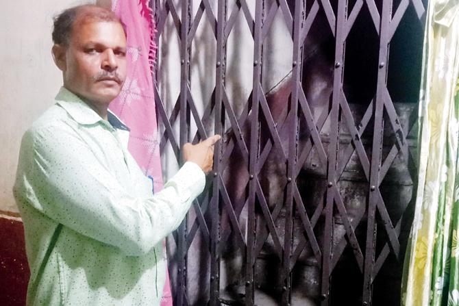 Sanjay Mhaske shows the staircase where he found the six-year-old girl dead in February 2010