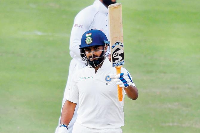 Rishabh Pant raises his bat after reaching 50 on Saturday
