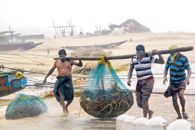 Fishermen at Gopalpur, in Ganjam, Odisha. Pics/PTI