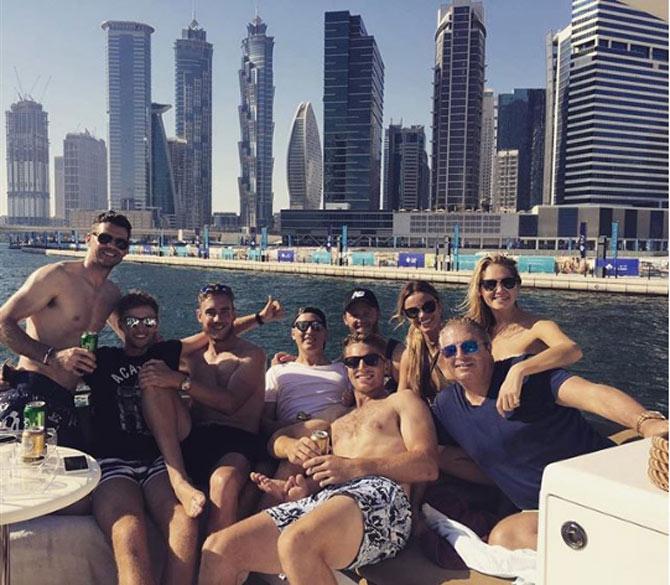 Louise Buttler with Jos Buttler and friends on a vacation in Dubai, with the scenic Dubai skyline as the backdrop