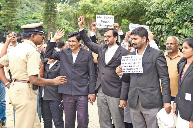 A policeman stops lawyers in Bengaluru protesting against the ongoing confinement of activists by Pune police on Friday. File Pics
