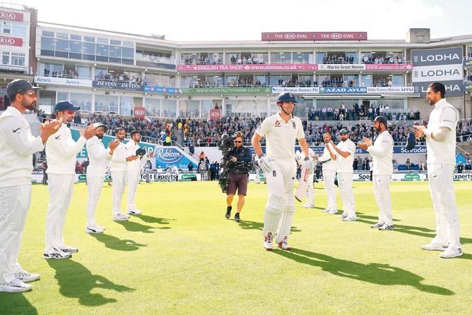 England opener Alastair Cook receives a guard of honour from Indian players as he walks out to bat on Day One at the Oval yesterday