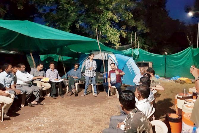 Deputy Conservator of Forest K M Abharna (standing), APCCF Sunil Limaye (speaking), to his left CCF, Yavatmal, Pradip Rahurkar and other officials at the base camp