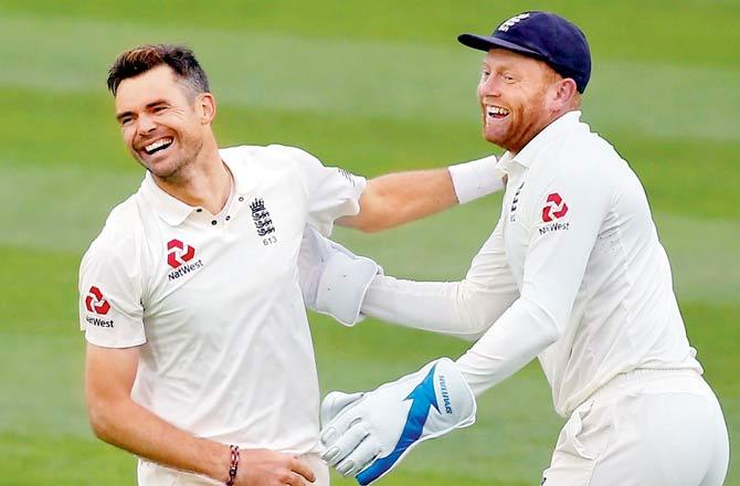 England pacer James Anderson (left) celebrates his Test wicket No. 564 after dismissing India