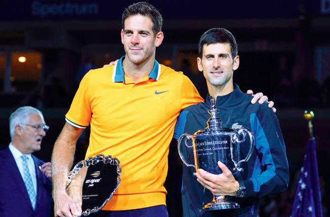 Novak Djokovic (right) and Juan Martin del Potro pose with their trophies. Pic/AFP