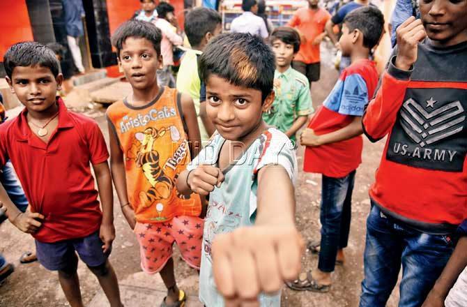  Shubham Kunchikorve, 13, and a group of children in Dharavi say they are not exposed to most sports, barring karate that schools offer. Pic/Pradeep Dhivar