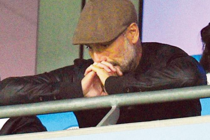 A suspended Man City boss Pep Guardiola watches his team play Lyon from the stands. Pic/AFP