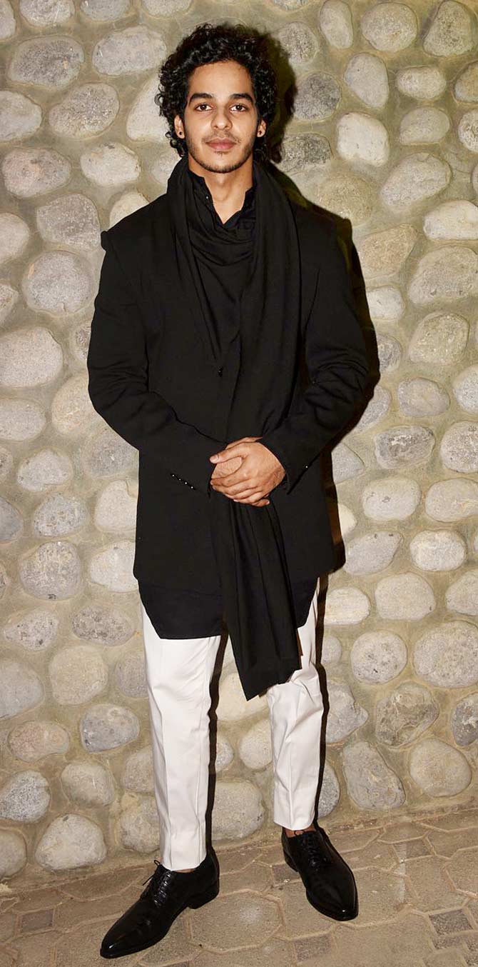 Ishaan Khatter made a chic style statement in a black tunic worn over white trousers. He tied a scarf around his neck and paired his look with sleek black boots.