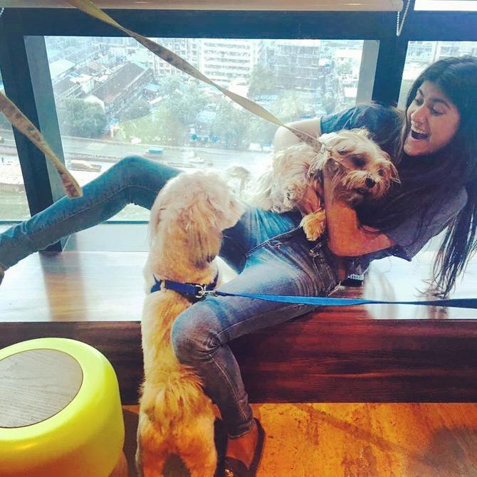 In photo: Ananya Birla gets playful as she cuddles Skai in her arms as the other pet dog looks on. She captioned the pic: I let the dogs out