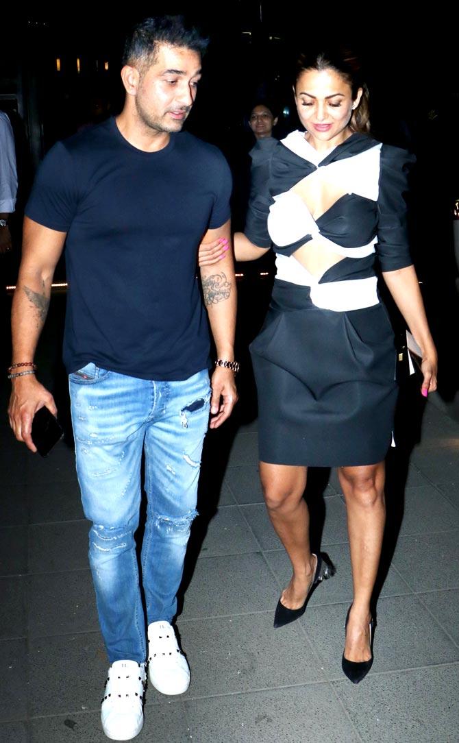 Shakeel Ladak sported a casual look - a basic blue t-shirt, paired with blue denims and white sneakers. Amrita Arora Ladak opted for a monochrome dress for the dinner outing. 