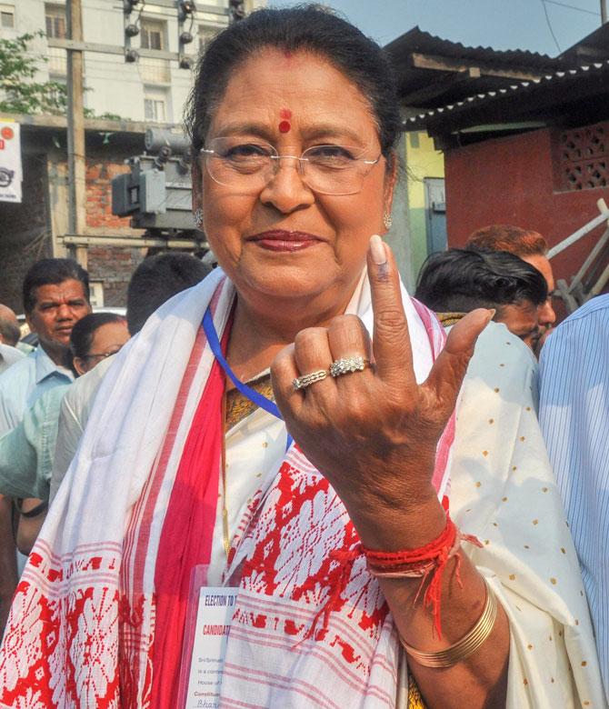 BJP Guwahati Lok Sabha candidate Queen Ojha shows her inked marked finger after casting vote, during the third phase of the 2019 Lok Sabha elections, at a polling station in Guwahati