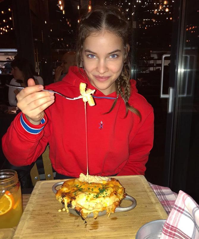 Barbara Palvin who is known for her incredibly curvy figure shared this picture of herself where she is seen cheating on her healthy lifestyle and bingeing on some delicious cheesy food.