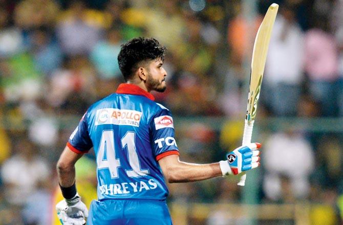 Delhi Capitals skipper Shreyas Iyer raises his bat after reaching his half-century against RCB yesterday