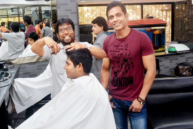 Junaid Shaikh (right) at 1940-established Precious Hairdressers, with one of its oldest employees, Ikram Hussain. "The Ambanis and movie stars to half the cricket world, including Sachin Tendulkar and Sanjay Manjrekar, have sat in our chairs," Junaid says. Pic/Sayyed Sameer Abedi