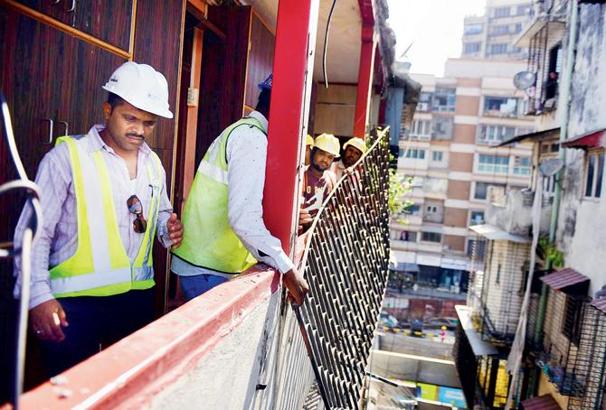 Metro officials cleaning the debris that the collapse had left in a balcony
