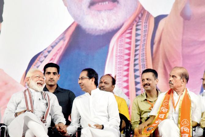 Prime Minister Narendra Modi and Shiv Sena chief Uddhav Thackeray share a laugh while holding hands in a show of solidarity during the rally at BKC yesterday, even as other party members look on. Pics/Nimesh Dave