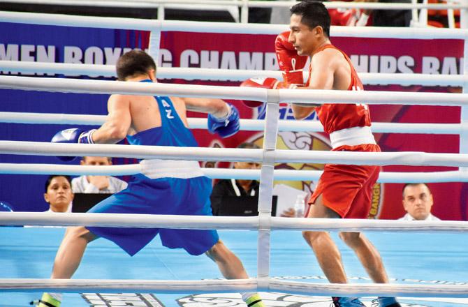 Kavinder Singh Bisht (in red) takes on Kairat Yeraliyey of Kazakhstan in the 52kg quarters