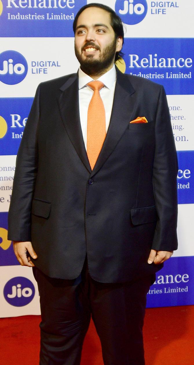 The youngest scion of the Ambani family, Anant Ambani opted for a black suit as he completed his formal look with an orange tie