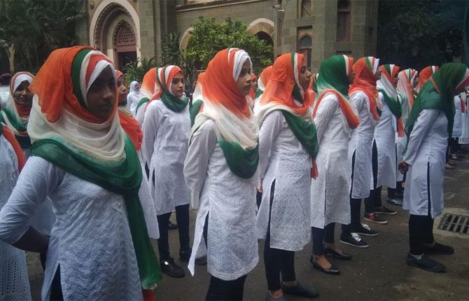 Students from the Anjuman Islam school share a light moment as they take part in the 73rd Independence Day celebrations, in Mumbai