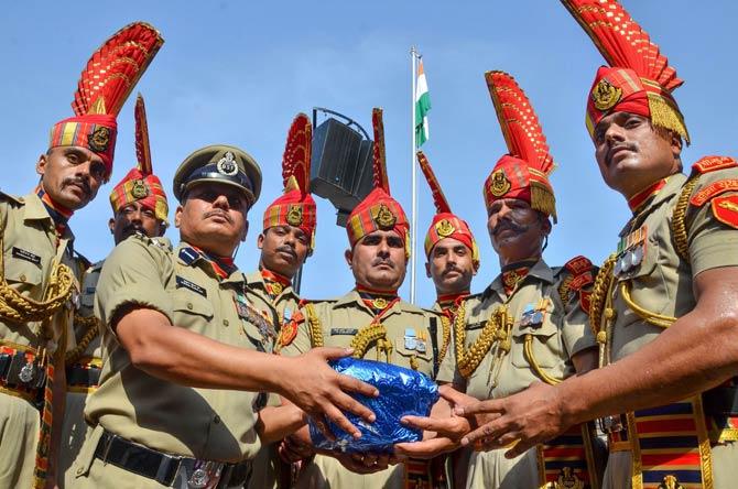 Border Security Force Commandant Mukund Kumar Jha offers sweets to BSF jawans on the occasion of 73rd Independence Day
