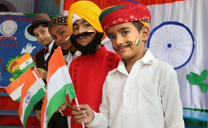 Schoolchildren, dressed as Hindu, Muslim, Sikh and Christian, celebrate Independence Day and Raksha Bandhan, in Ajmer